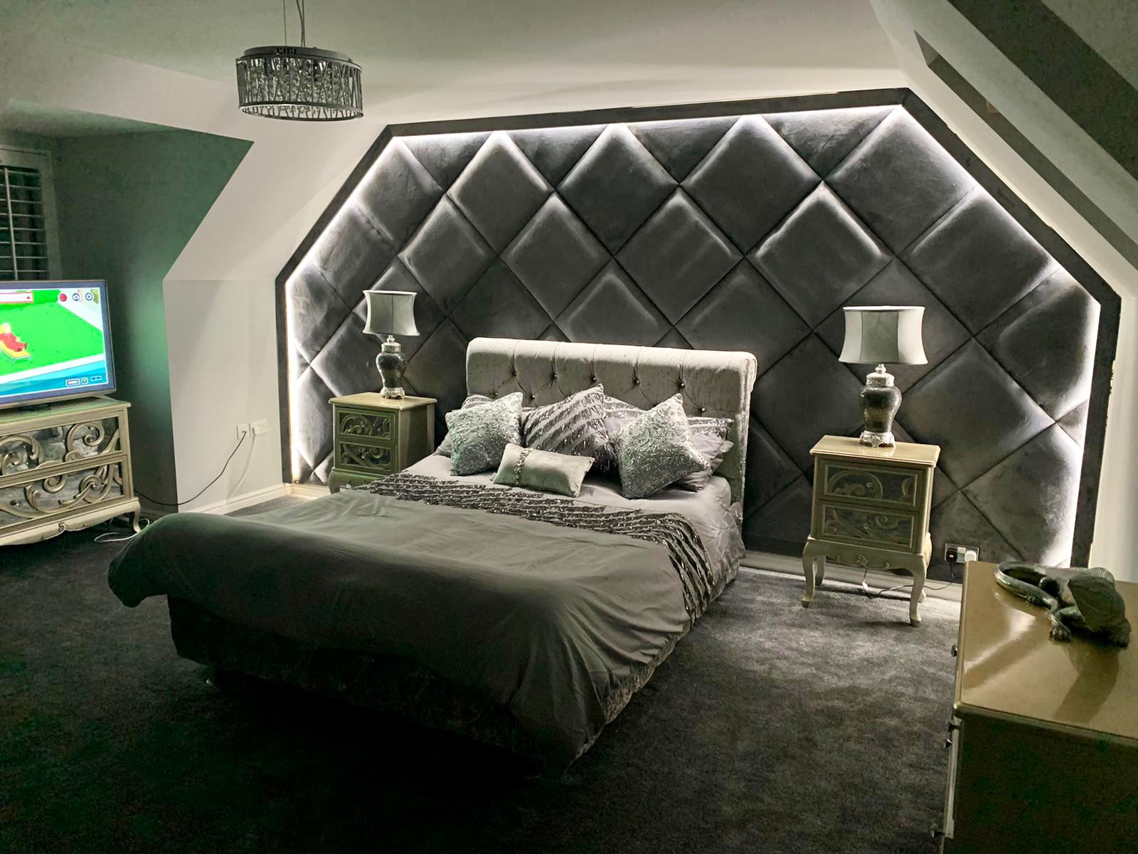 Bespoke upholstered velvet panel wall in a luxury bedroom installation